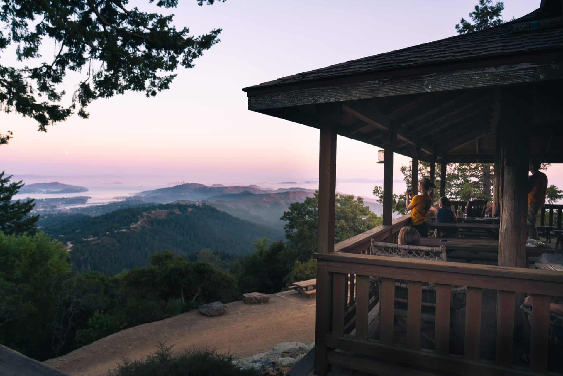 West Point inn balcony with hills in distance and pink sunset in sky