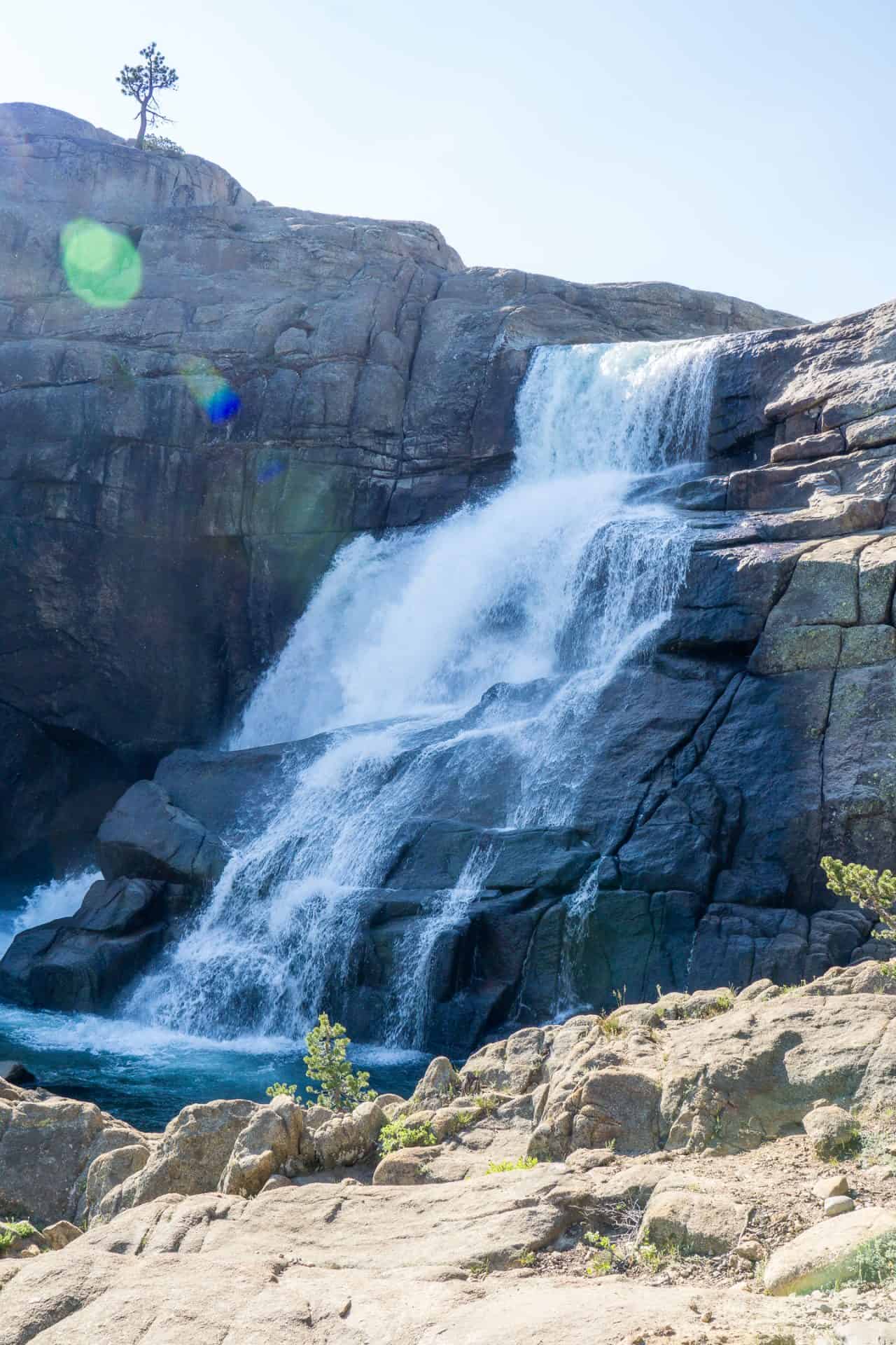 A waterfall is seen in the middle of a rocky area.