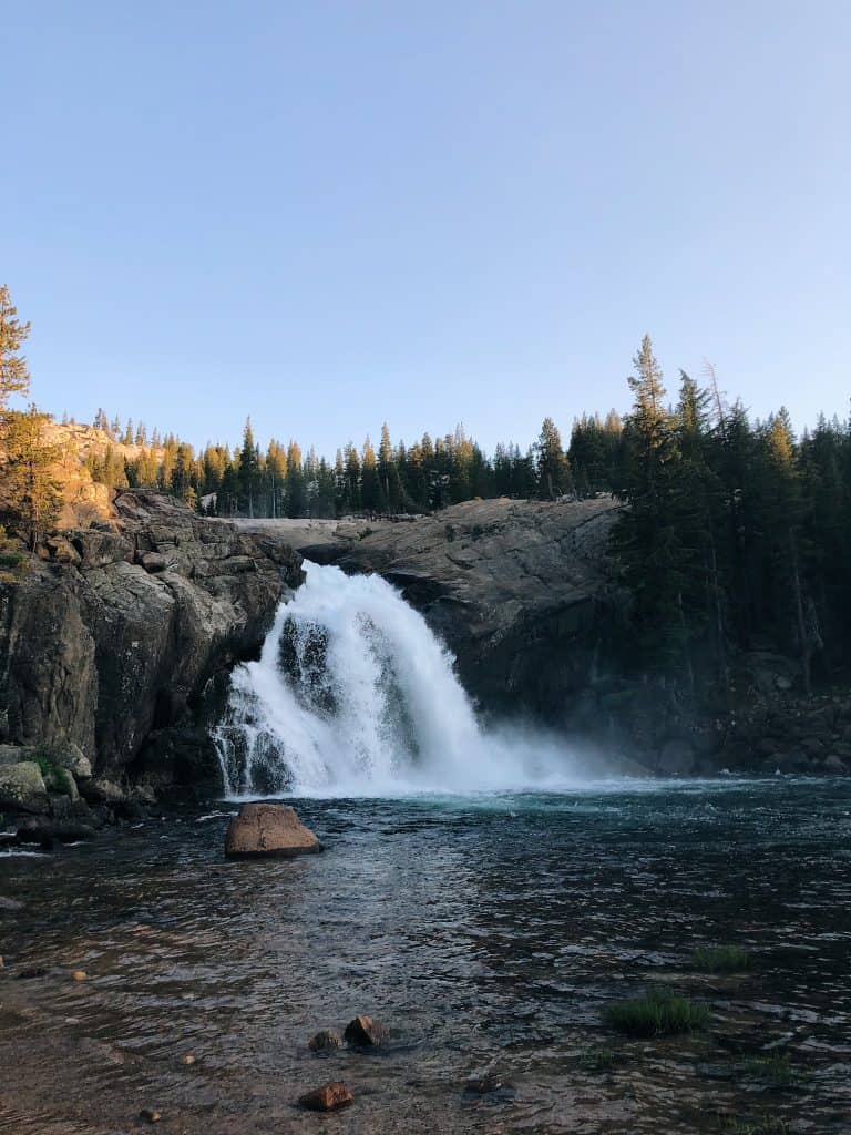 a small but powerful waterfall flowing into a pool in the tuolumne river at Glen Aulin in yosemite