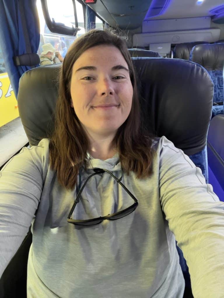 author Emily sitting on bus by herself