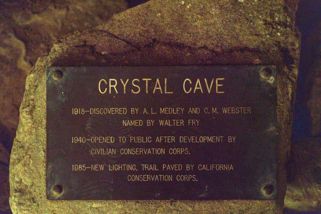 A plaque outside of the Crystal Cave entrance outlining a brief history of the discovery of the cave.