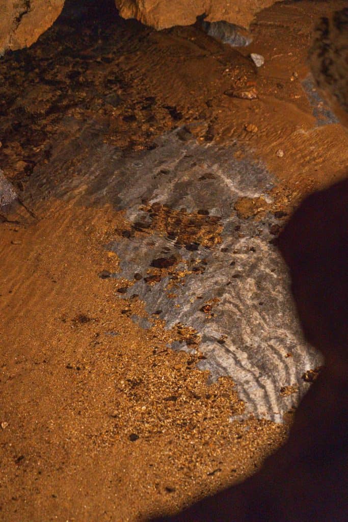 A section of marble underneath a pool of water in the Crystal Cave.