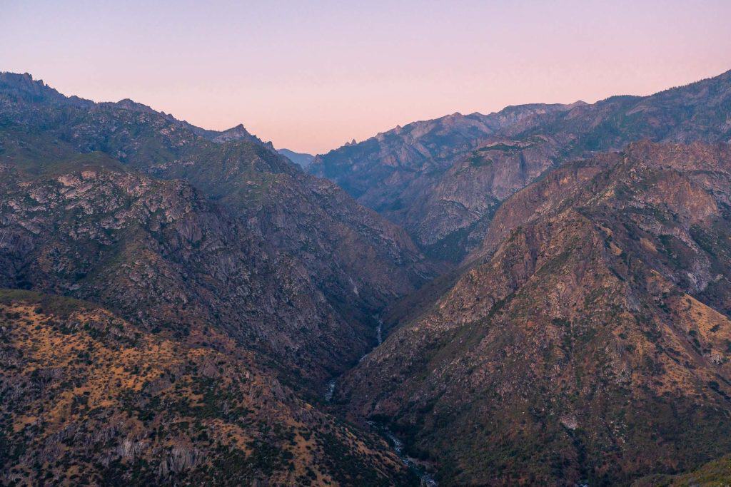 Kings Canyon during sunset with rugged peaks and valleys as seen from the scenic byway.