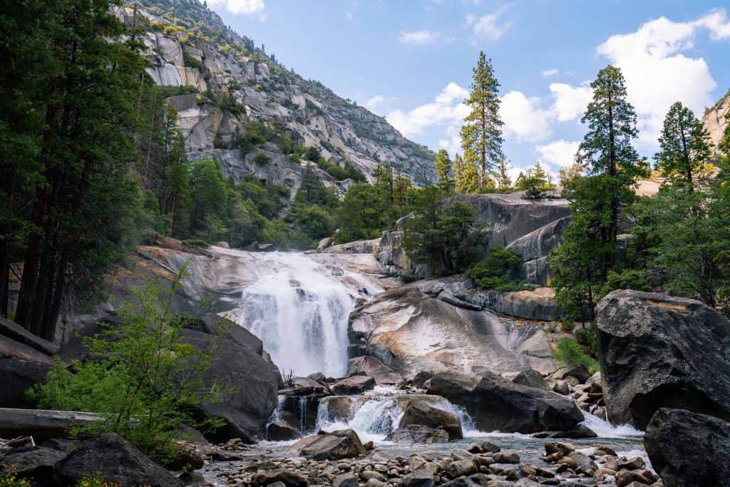 Mis Falls waterfall cascading off granite cliff in Kings Canyon National Park. A highlight of a day trip to Kings Canyon.